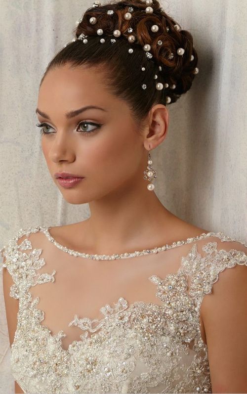 Curly hair bun hairstyle for wedding with beads