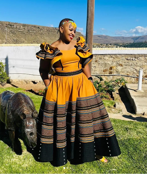 Beige and black Xhosa Makoti dress by Uqinqaba Designs