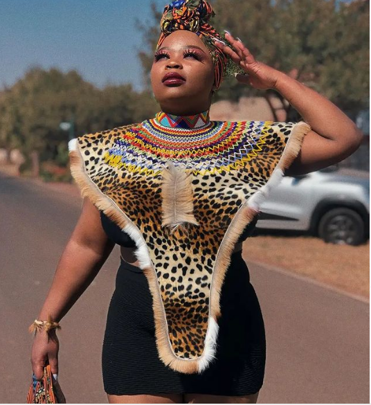 https://www.sunika.co.za/images/Short_Black_Zulu_Dress_with_Animal_print_Bib_2022.png