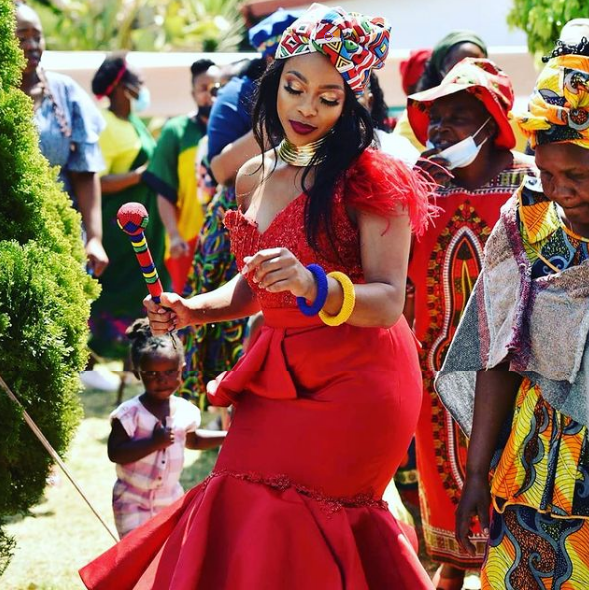 Red wedding dress with Ndebele print doek